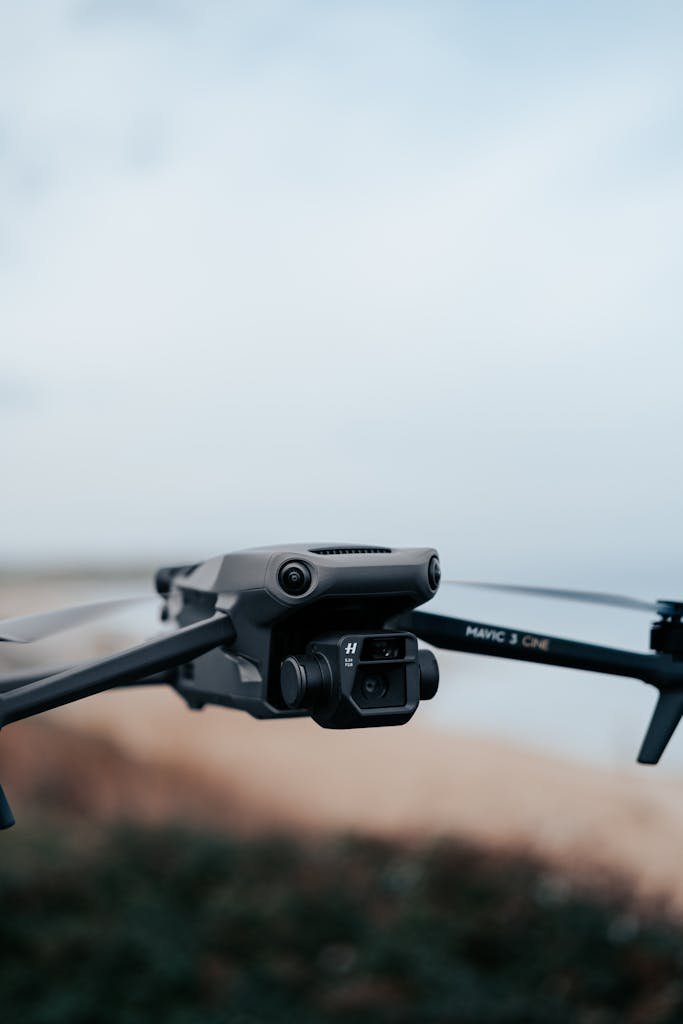 Close-up view of a drone flying against a serene blue sky, showcasing modern technology.